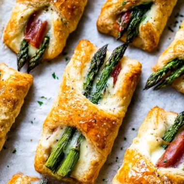 Asparagus Puff Pastry Bundles on a serving plate garnished with herbs
