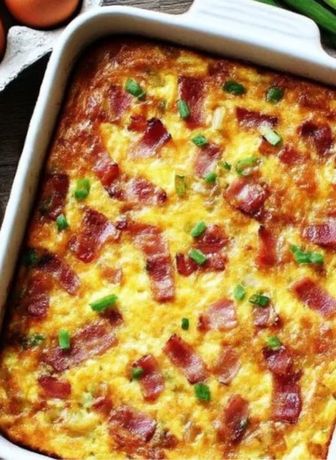 Bacon Potato Egg Casserole served in a baking dish with herbs on top.
