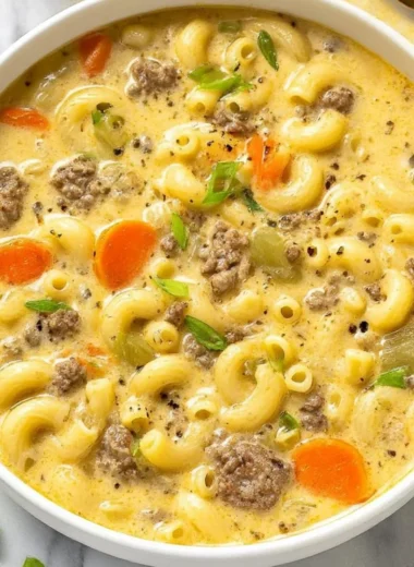 Bowl of delicious cheeseburger soup topped with cheese and cilantro