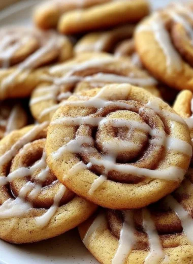 Delicious cinnamon roll cookies with a swirl of cinnamon and icing on top