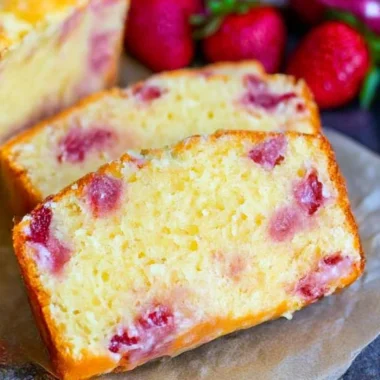 Cozy strawberry pound cake topped with fresh strawberries and cream