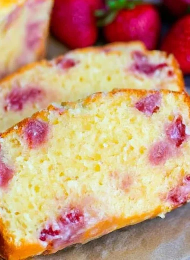 Cozy strawberry pound cake topped with fresh strawberries and cream