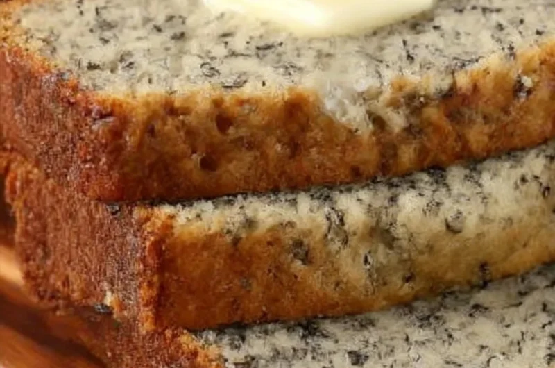 Delicious slices of easy homemade banana bread on a wooden table