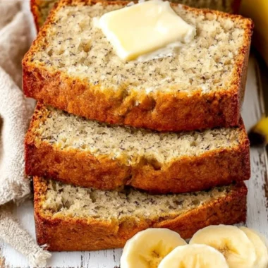 A loaf of easy moist banana bread with slices cut, showcasing its soft texture.