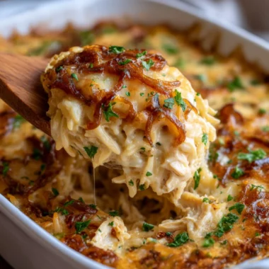 Delicious French Onion Chicken Orzo Casserole topped with cheese and herbs.