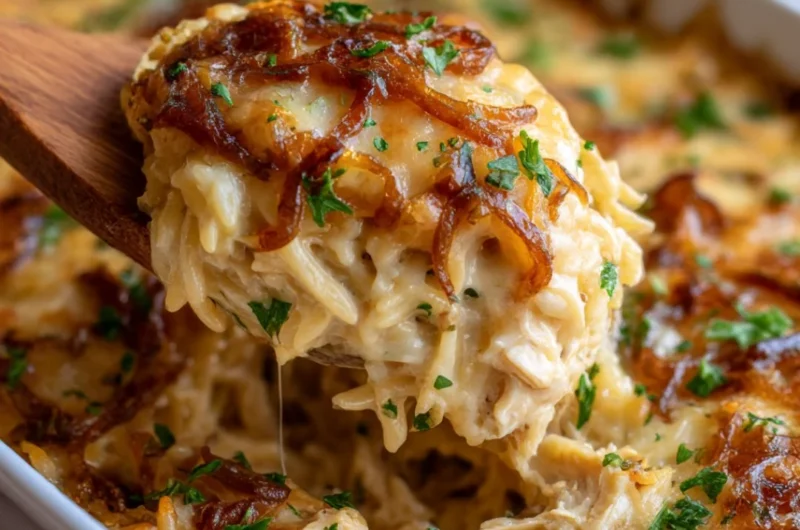 Delicious French Onion Chicken Orzo Casserole topped with cheese and herbs.