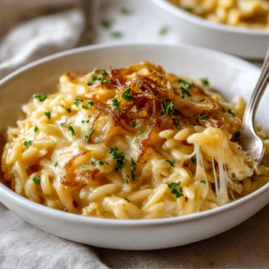 Delicious French Onion Orzo Bake topped with melted cheese and herbs