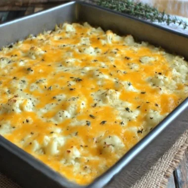 A serving of green chile cauliflower casserole topped with cheese