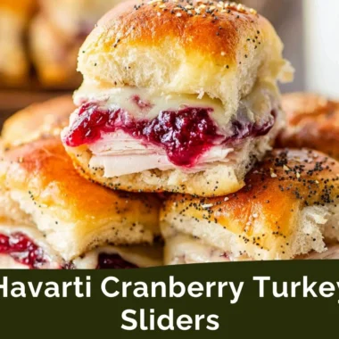 Havarti cranberry turkey sliders garnished with fresh herbs on a platter.