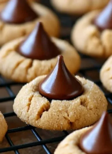 Plate of freshly baked Hershey Kiss Cookies topped with chocolate kisses