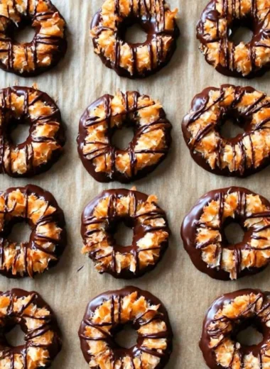 Plate of homemade Samoas cookies topped with chocolate and caramel.