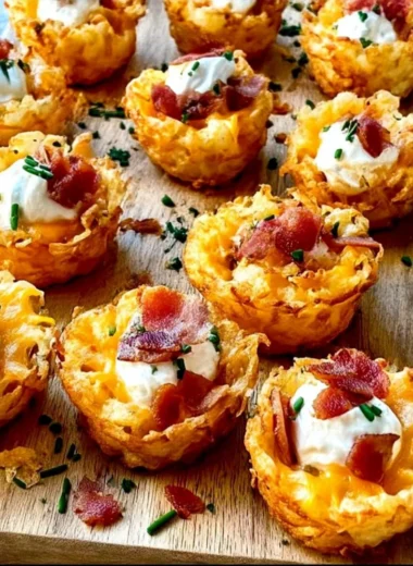 Loaded tater tots appetizers topped with cheese and toppings.