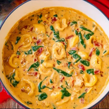 A hearty bowl of Marry Me Tuscan Chicken Soup with fresh herbs and vegetables.
