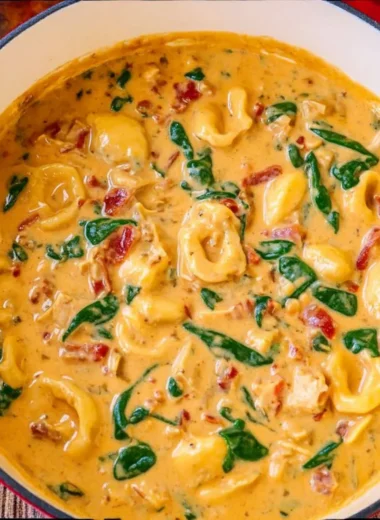 A hearty bowl of Marry Me Tuscan Chicken Soup with fresh herbs and vegetables.