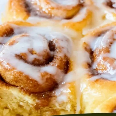 Delicious viral TikTok cinnamon rolls drizzled with icing on a plate.