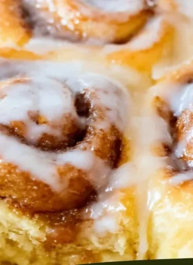 Delicious viral TikTok cinnamon rolls drizzled with icing on a plate.