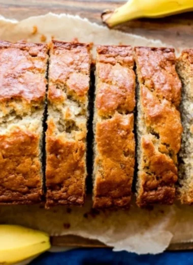 Delicious homemade banana bread sliced on a wooden cutting board