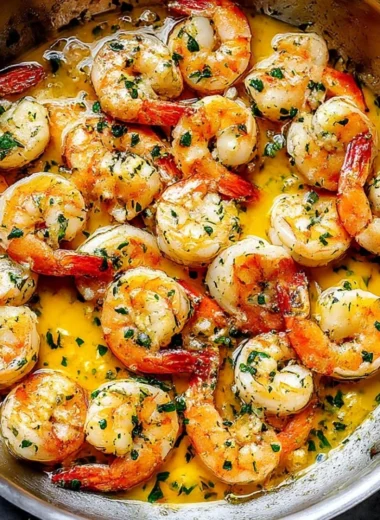 Delicious plate of shrimp scampi garnished with herbs and lemon.