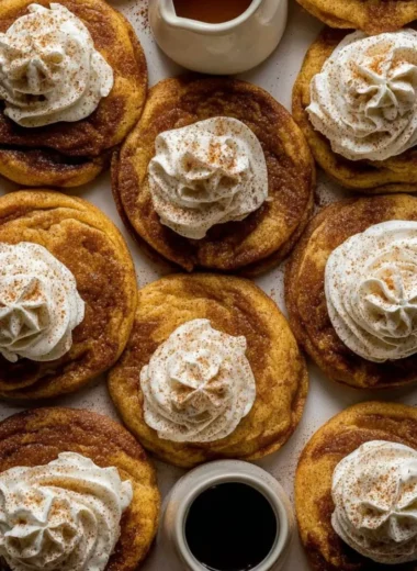 Chewy French toast cookies on a plate with syrup drizzle.