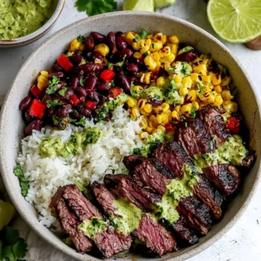 Bowl of cilantro lime steak with fresh vegetables and rice.