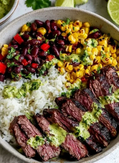 Bowl of cilantro lime steak with fresh vegetables and rice.