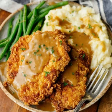 Delicious country fried chicken breast served with sides