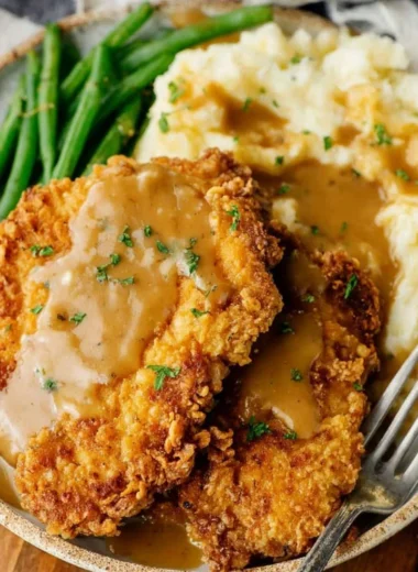 Delicious country fried chicken breast served with sides