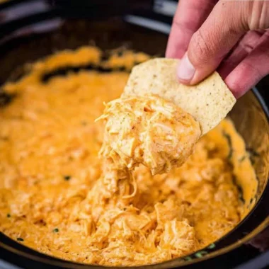 Cozy creamy chicken dip served in a bowl with dipping chips