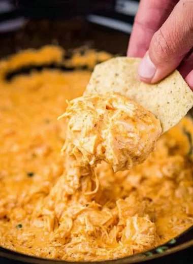 Cozy creamy chicken dip served in a bowl with dipping chips