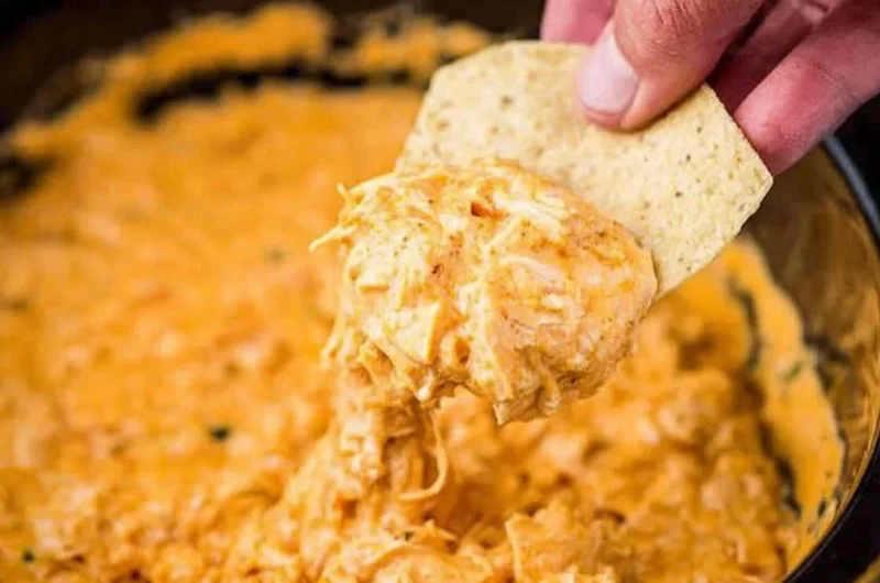 Cozy creamy chicken dip served in a bowl with dipping chips