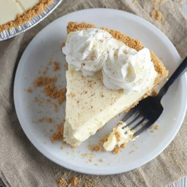 Cozy eggnog dessert topped with whipped cream and holiday spices