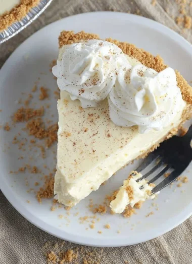 Cozy eggnog dessert topped with whipped cream and holiday spices