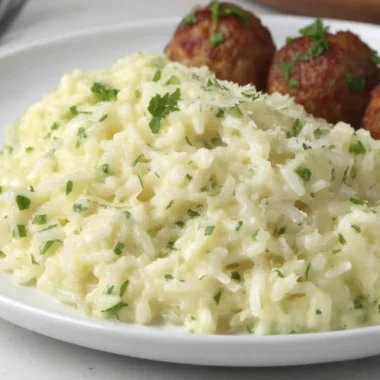 Cozy Garlic Parmesan Rice dish garnished with parsley in a bowl.