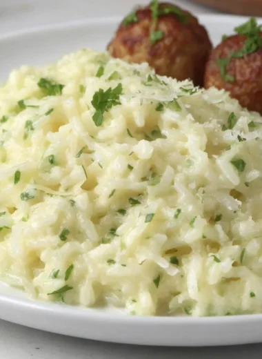 Cozy Garlic Parmesan Rice dish garnished with parsley in a bowl.