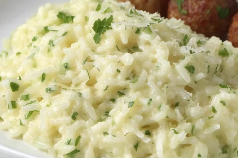 Cozy Garlic Parmesan Rice dish garnished with parsley in a bowl.