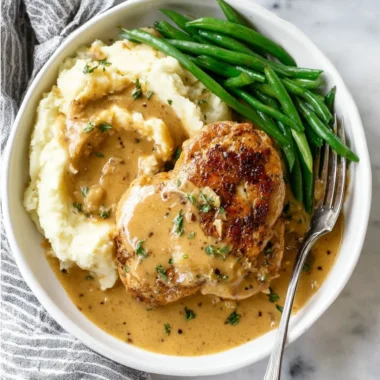 Plate of creamy garlic chicken garnished with herbs