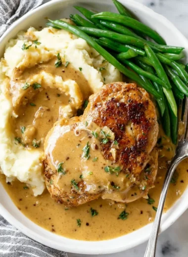 Plate of creamy garlic chicken garnished with herbs