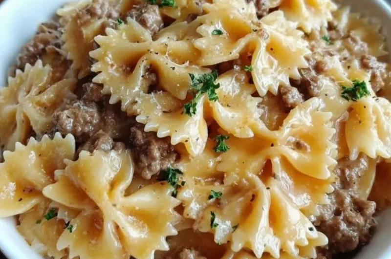Delicious Garlic Butter Beef served with Cheesy Bowtie Pasta on a plate