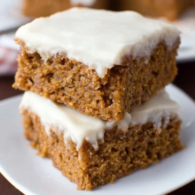 Delicious slices of healthy applesauce cake on a wooden platter.