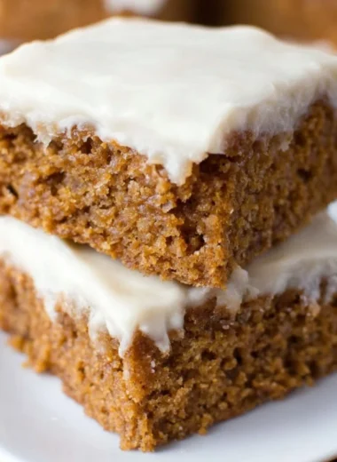 Delicious slices of healthy applesauce cake on a wooden platter.