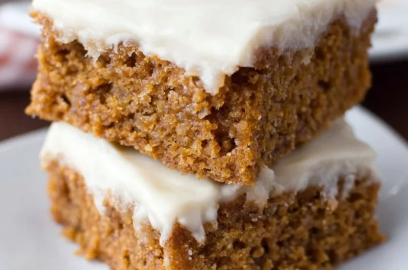 Delicious slices of healthy applesauce cake on a wooden platter.