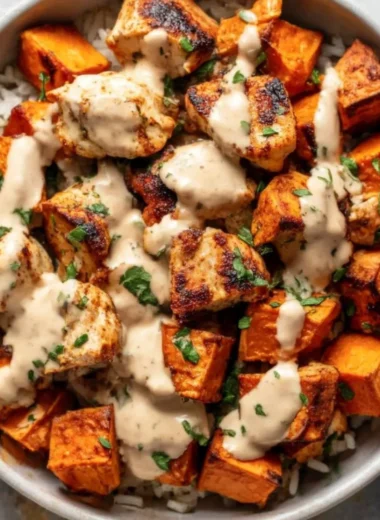 Healthy chicken rice bowl with sweet potatoes and colorful vegetables