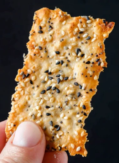 Homemade sourdough crackers displayed on a rustic wooden board