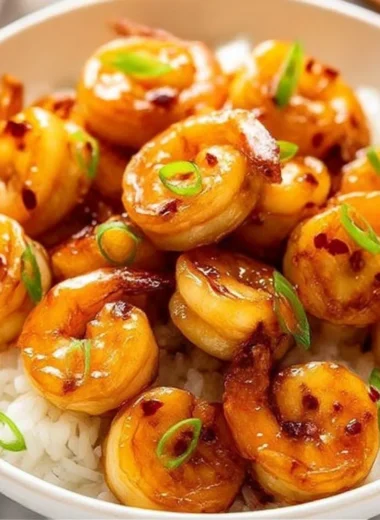 Plate of Honey Garlic Shrimp garnished with green onions and sesame seeds