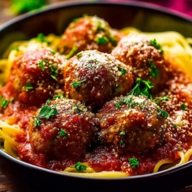 Delicious Italian meatballs served with marinara sauce and fresh herbs