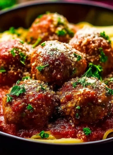 Delicious Italian meatballs served with marinara sauce and fresh herbs