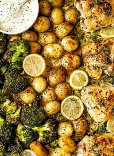 Tender Lemon Garlic Chicken garnished with fresh herbs and served on a plate.