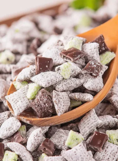 Bowl of Mint Chocolate Puppy Chow with chocolate and mint decorations