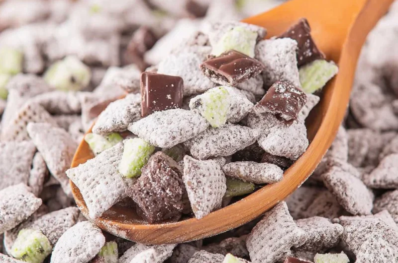 Bowl of Mint Chocolate Puppy Chow with chocolate and mint decorations