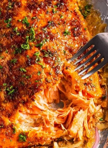 Delicious oven baked salmon garnished with herbs and lemon